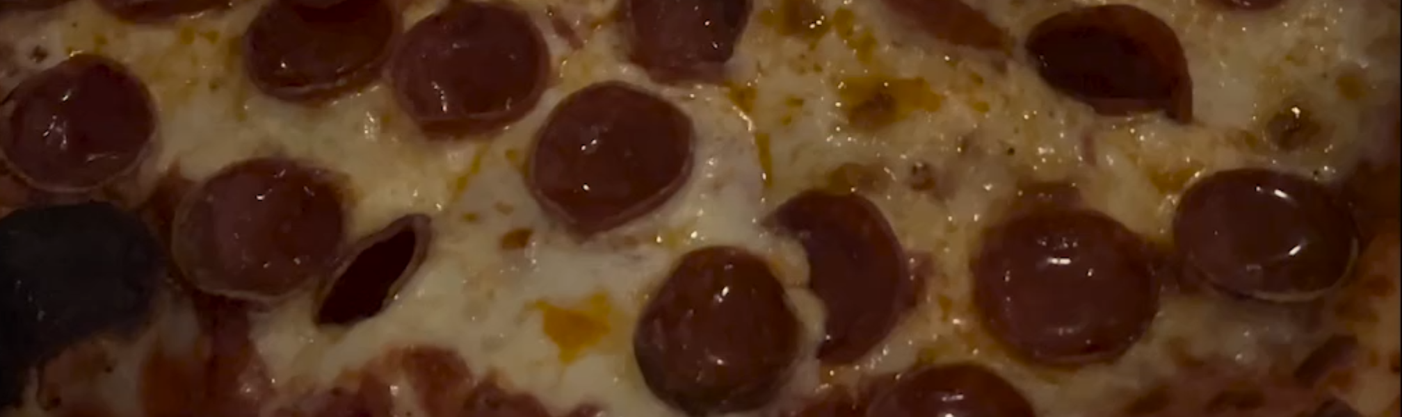 A close-up of a pepperoni and cheese pizza.